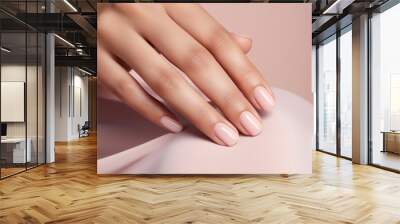 Glamour woman hand with nude nail polish on her fingernails. Nude shade nail manicure with gel polish at luxury beauty salon. Nail art and design. Female hand model. French manicure. Wall mural