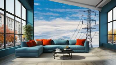 High voltage electric pole and transmission line. Electricity pylons. Power and energy. Energy conservation. High voltage grid tower with wire cable at distribution station against blue sky and cloud. Wall mural