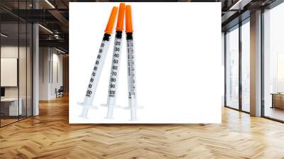 Plastic insulin syringes for diabetes. Needle for addict. Three insulin syringes with orange cover isolated on white background. Injection medicine. Medical equipment for diabetic. Vaccination concept Wall mural