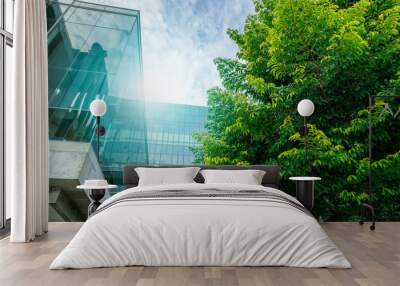 Sustainable green building. Eco-friendly building. Sustainable glass office building with trees for reducing carbon dioxide. Green company office with green environment. Corporate building reduce CO2. Wall mural