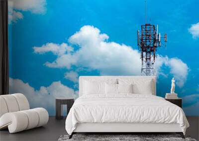 Telecommunication tower with blue sky and white clouds background. Antenna on blue sky. Radio and satellite pole. Communication technology. Telecommunication industry. Mobile or telecom 4g network. Wall mural