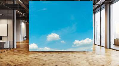 White fluffy cumulus clouds on blue sky with copy space for text. White puffy cloudscape. Beauty in nature. Close-up white cumulus clouds texture background. Sky on sunny day. Pure white clouds. Wall mural