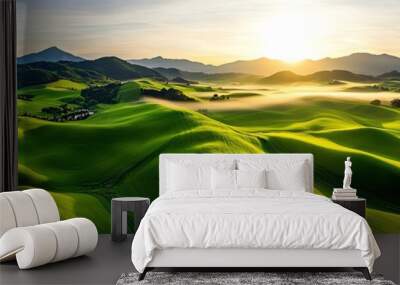 A breathtaking view of rolling green hills illuminated by a golden sunrise, capturing the beauty of nature's landscapes. Wall mural