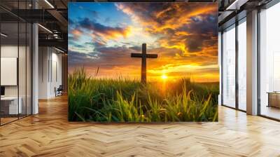 Large wooden cross is standing in a grass field with a beautiful sunset in the background Wall mural