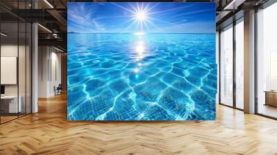 Sun shining on a clear blue water swimming pool surrounded by trees and vegetation Wall mural