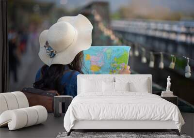 Female tourists on hand have a happy travel map. Wall mural