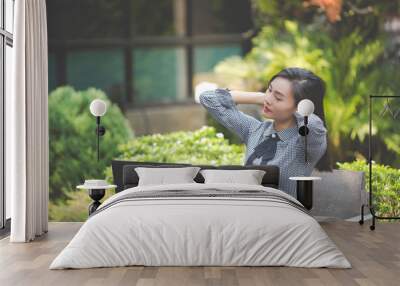 Woman is suffering from fatigue from work. Wall mural