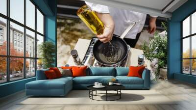 Chef Preparing Olive Oil in a Pan for Making Rosemary Oil. Wall mural