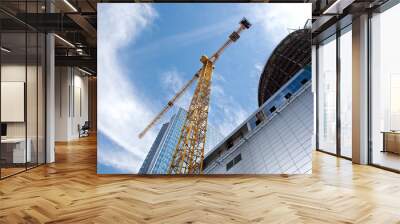 Modern building under construction against blue sky Wall mural