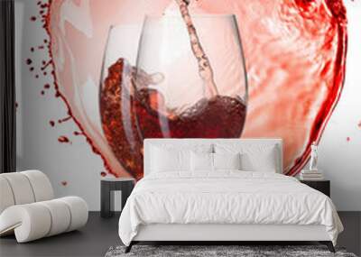 Red wine pouring into glasses with splash against heart isolated Wall mural