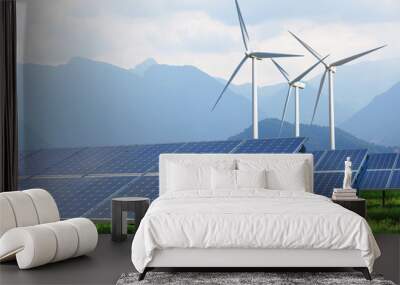 solar panels and wind turbines against mountains Wall mural