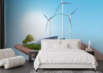 Wind turbines and solar panels in female hand Wall mural