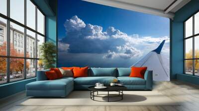 Wing of aircraft on a background of clear blue sky. Wall mural