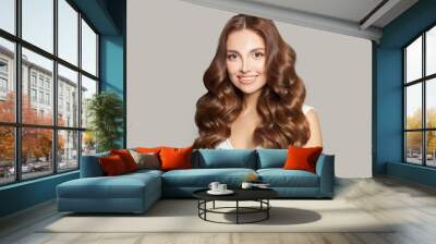 Attractive woman with long and shiny curly hair . Beautiful model woman with curly hairstyle. Care and beauty of hair concept Wall mural