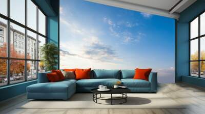 Blue sky clouds background. Beautiful landscape with clouds and orange sun on sky Wall mural