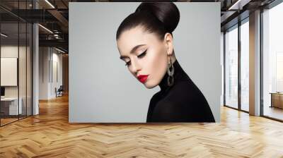 Elegant Young Woman with Hair Bun Hairstyle and Eyeliner Make up. Female Model wearing Black Roll Neck Jumper. Wall mural