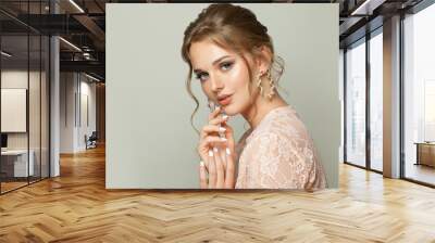 Nice young woman on gray background Wall mural