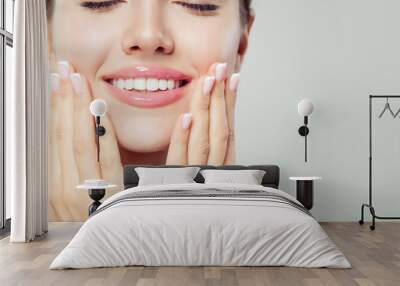 Perfect woman smile and manicured hand. French manicure and pink lipgloss makeup Wall mural