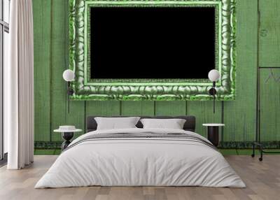 Photo frame hanging on the green blurred wall - old album backgr Wall mural