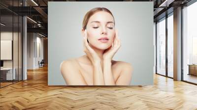 Pretty woman with closed eyes  and young healthy skin. Facial treatment, face lifting, anti aging and skin care concept. Wall mural