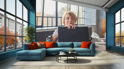 Senior woman with laptop indoors Wall mural