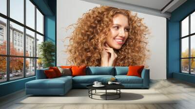 woman fashion model with long wavy hairstyle, natural makeup and clear skin. Haircare, facial treatment and skincare concept Wall mural