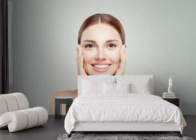 Young perfect female model face. Beautiful girl with healthy skin. Skin care and cosmetology concept. Wall mural