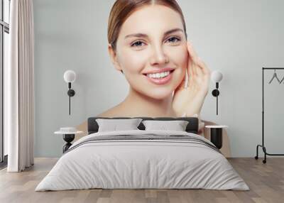 Young smiling woman. Perfect girl with clear skin and cute smile. Skincare and cosmetology concept. Wall mural