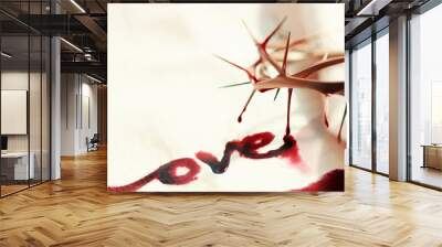 A crown of thorns symbolizing the sacrifice and suffering of Jesus Christ, the cross, love and blood, and the lettering LOVE, Passion Week and Lent Easter concept
 Wall mural