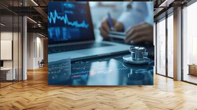 Close-up of a stethoscope on a laptop screen showing medical data, a doctor working on a laptop with medical charts, a concept of healthcare technology and analytics. Wall mural