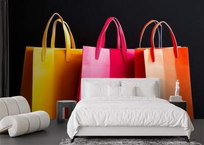 Vibrant shopping bags in yellow, pink, and orange against a black backdrop, representing retail and fashion. Black Friday sale concept with place for text Wall mural