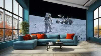 Astronaut near the moon rover on the moon. With land on the horizon. Elements of this image were furnished by NASA. Wall mural