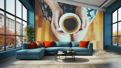 A close-up portrait of a young woman enjoying a cup of coffee in a cozy cafe. The background is softly blurred. Beautiful simple AI generated image Wall mural