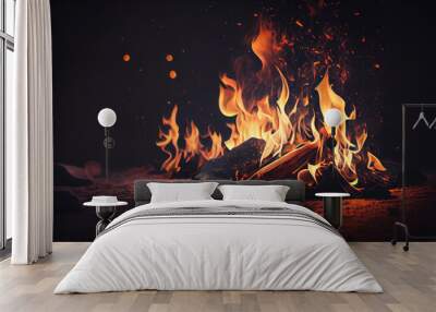 Burning wood at night. Campfire at touristic camp at nature in mountains. Flame amd fire sparks on dark abstract background. Wall mural