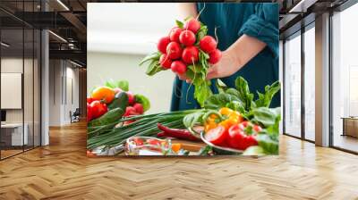 Beautiful young woman holding bouquet of fresh pink radish. Concept of clean eating, healthy food, low calories meal, vegetarian dieting, self caring lifestyle. Vegetables from market on a table Wall mural