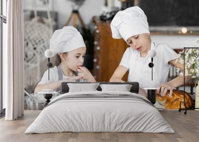 Brother and sister baking homemade sweet pie together, having fun. Home bakery, little kids in process of food preparation in the kitchen at home, helping mother, doing chores Wall mural