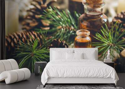 Christmas home aromatherapy. Aroma diffuser with pine extract, organic essential oil, cedar and spruce cone, candles on wooden table. Cozy atmosphere holiday spirit. Winter inspiration and mood banner Wall mural