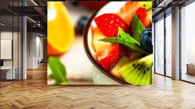 Concept of low calories delicious desserts. Summer fresh bowl with colorful fruit salad. Healthy natural organic food. Tasty sweet snack, light simple tasty lunch. Close up macro view. Banner Wall mural