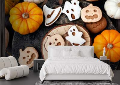 Homemade halloween holiday treats for kids. Gingerbread cookies on wooden board, decorated with pumpkins and autumn leaves. Top view Wall mural