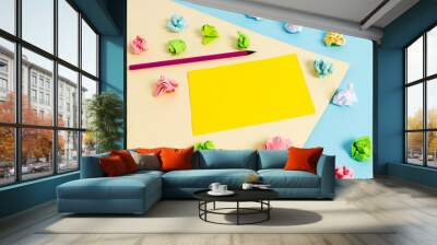 Colored crumpled papers empty reminder blue yellow background clothespin Wall mural