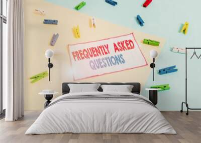 Conceptual hand writing showing Frequently Asked Questions. Concept meaning inquries that been informed more than one time Colored clothespin paper reminder with yellow blue background Wall mural