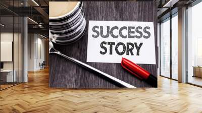 Conceptual hand writing text caption showing Success Story. Business concept for Inspiration Motivation written on sticky note paper on the wooden wood background. With coffee and marker Wall mural