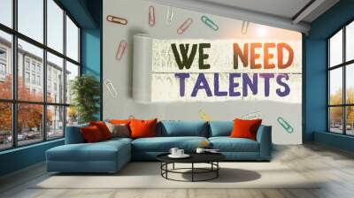 Handwriting text We Need Talents. Conceptual photo seeking for creative recruiters to join company or team Paper clip and torn cardboard placed above a wooden classic table backdrop Wall mural