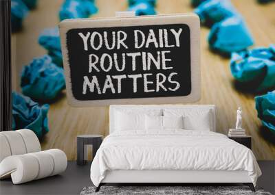 Handwriting text writing Your Daily Routine Matters.. Concept meaning Have good habits to live a healthy life Stand blackboard with white words behind blurry blue paper lobs woody floor. Wall mural