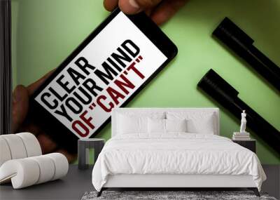 Text sign showing Clear Your Mind Of Can t not. Conceptual photo Have a positive attitude thinking motivation Man's hand hold phone with black and red words near two black marker Wall mural