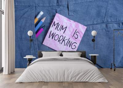 Text sign showing Mum Is Working. Business photo text Financial Empowerment and professional progressing mother Writing equipment and pink note paper inside pocket of man work trousers Wall mural