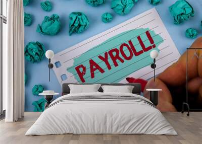 Text sign showing Payroll Motivational Call. Conceptual photo Total salaries paid by a company to its employees written by Man Painted Notepad Paper holding Marker plain background Paper Balls. Wall mural