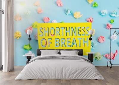 Text sign showing Shorthness Of Breath. Business photo text intense tightening of the airways causing breathing difficulty Colored crumpled papers empty reminder blue floor background clothespin Wall mural