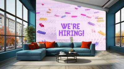 Text sign showing We Are Re Hiring. Business photo text process of reviewing applications and finding candidates Green clothespin white wood background colored paper reminder office supply Wall mural