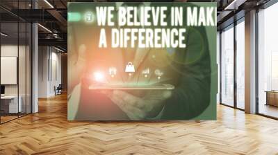 Text sign showing We Believe In Making A Difference. Business photo text selfconfidence that can be unique Male human wear formal work suit presenting presentation using smart device Wall mural